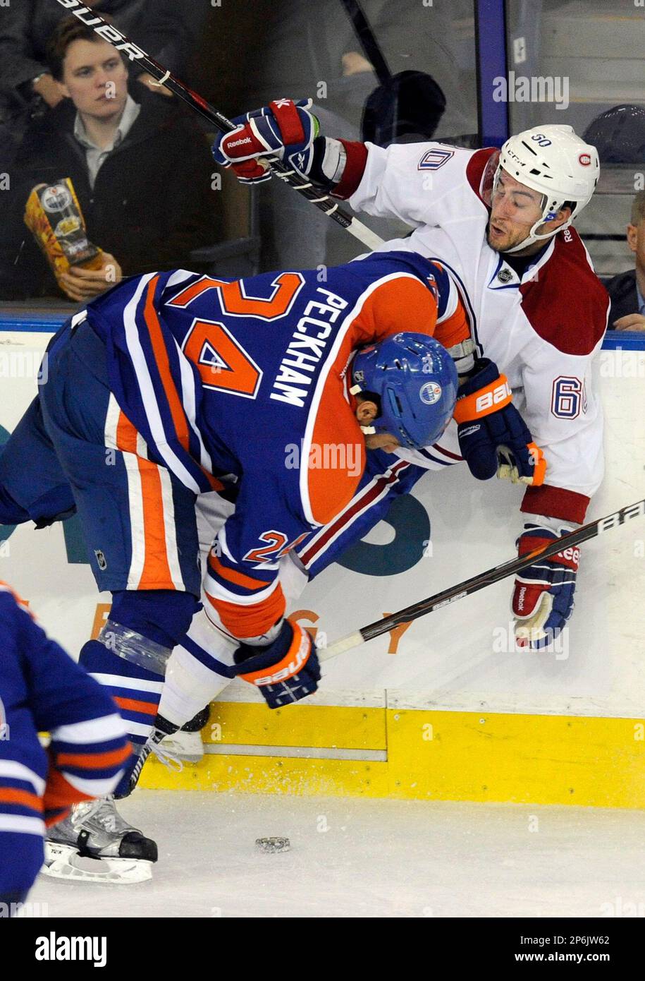 Edmonton Oilers' Theo Peckham, left, checks Montreal Canadiens' Aaron Palushaj during the second period of an NHL hockey game, Thursday, March 8, 2012, in Edmonton, Alberta. (AP Photo/The Canadian Press, John Ulan) Banque D'Images
