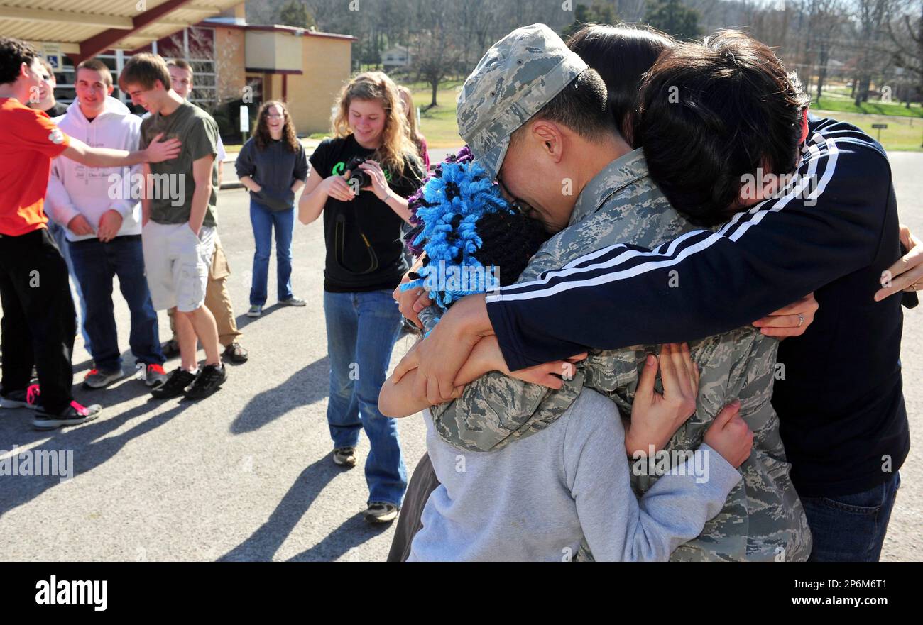Air Force Maj. Alan Villanueva gets mobbed by his wife, Carmen, and his children, Ruthann, 10, Sara, 12, Alan, 15, Elizabeth, 17, after surprising his family by returning home after a year-long tour in Kyrgyzstan on Friday, Feb, 17, 2012 in Huntsville, Ala. Villanueva surprised his family while they were posing for a group photo before leaving for a church trip. (AP Photo/The Huntsville Times, Eric Schultz) Banque D'Images