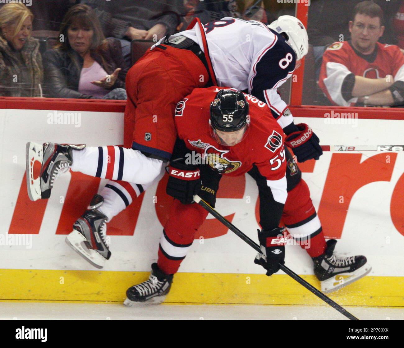 Ottawa Senators' Sergei Gonchar (55) checks Columbus Blue Jackets' Maksim Mayorov (8) into the boards during the first period of an NHL hockey game Saturday, Oct. 22, 2011, in Ottawa. (AP Photo/The Canadian Press, Fred Chartrand) Banque D'Images