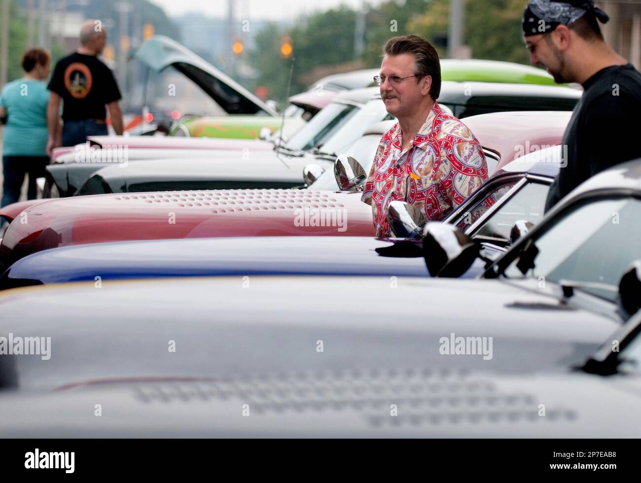 Gary Errigo of Dearborn walks through rows of classic cars with his stepson, Mario Frattarelli also of Dearborn during Back to the Bricks in downtown Flint, Mich., Saturday, Aug. 21, 2010. (AP Photo/The Flint Journal, Hollyn Johnson) Banque D'Images