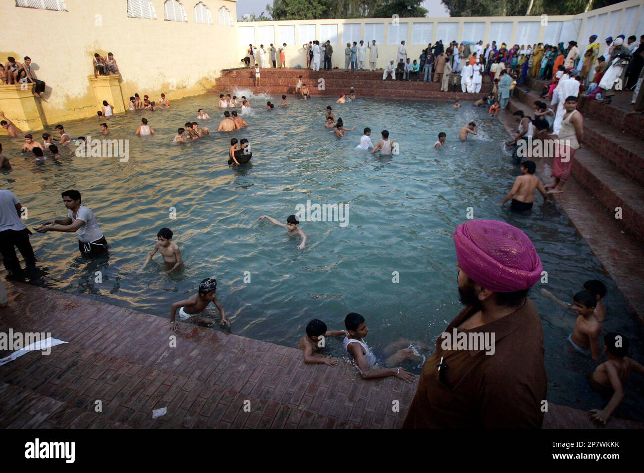 Sikh pilgrims take a holy bath during their visit to a temple Gurdwara