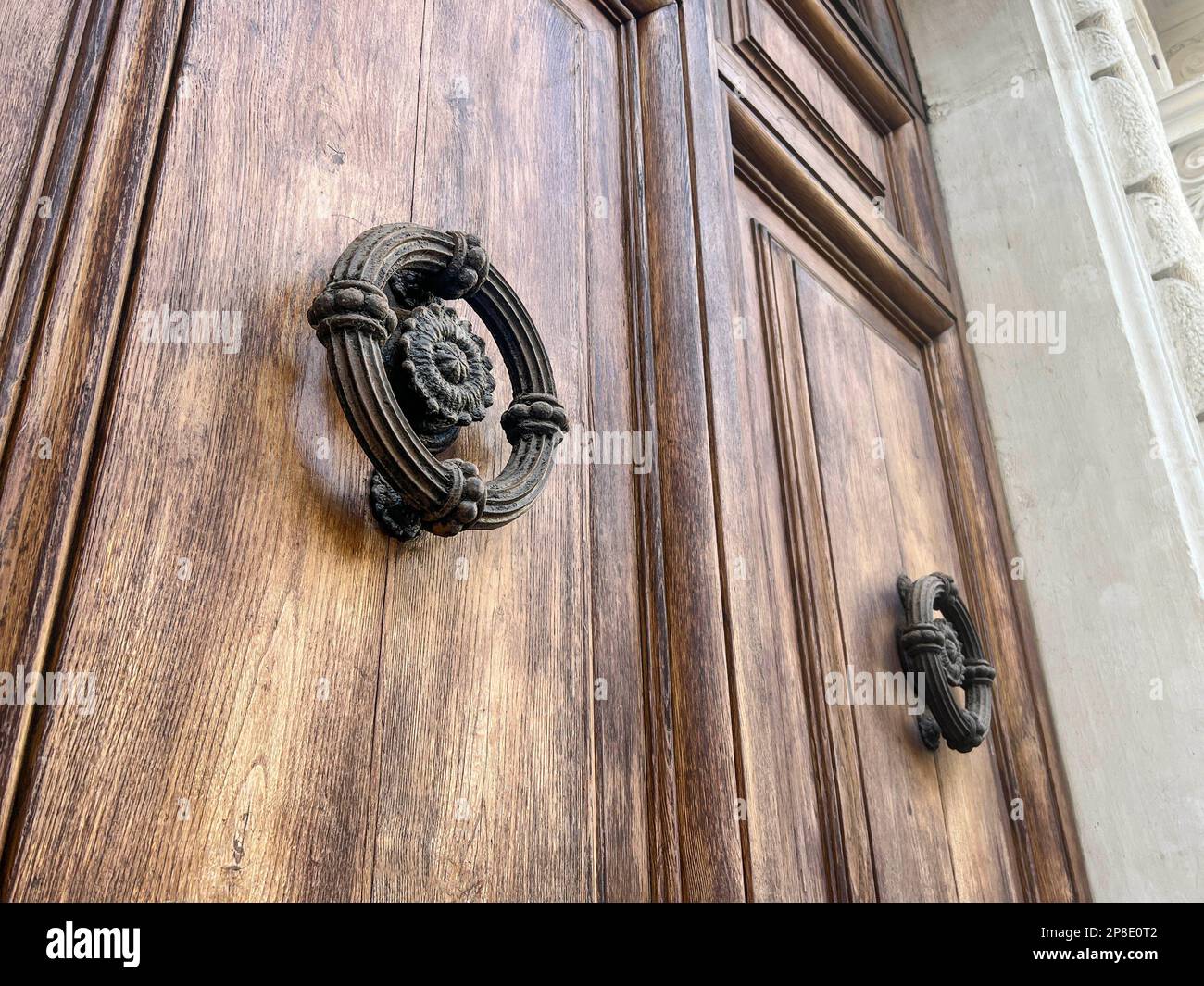 porte, porte en bois avec boutons de porte circulaires ou knockers. entrée principale d'un bâtiment. boutons ou poignées de porte en gros plan à l'entrée d'une maison ou d'un bâtiment Banque D'Images