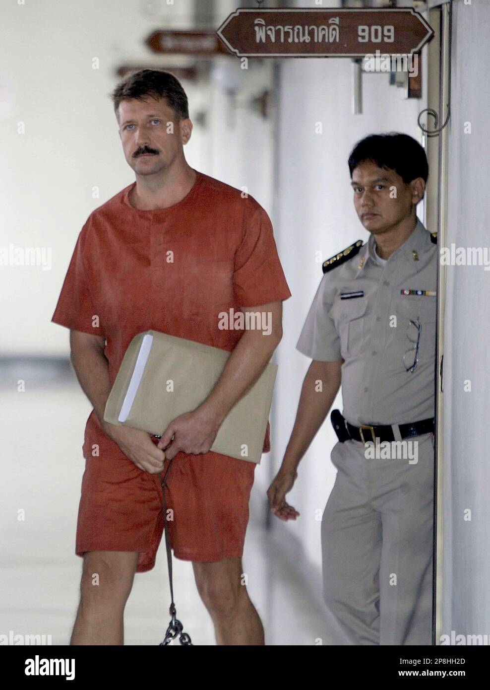 Alleged Russian arms dealer Viktor Bout, left, walks out of the court room at criminal court in Bangkok, Thailand Wednesday, April 29, 2009. Thailand said Wednesday it will not interfere in the politically charged extradition hearing of an alleged Russian arms smuggler whom the United States wants to put on trial but Russia wants sent home. (AP Photo/Apichart Weerawong) Banque D'Images