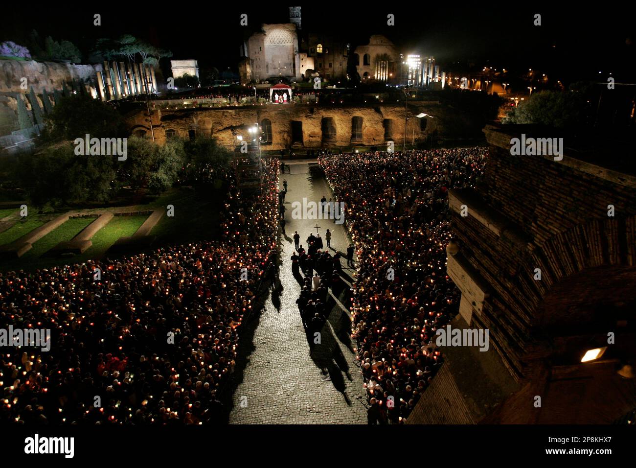 Faithful Hold A Wooden Cross As They Walk In Procession During The Via ...