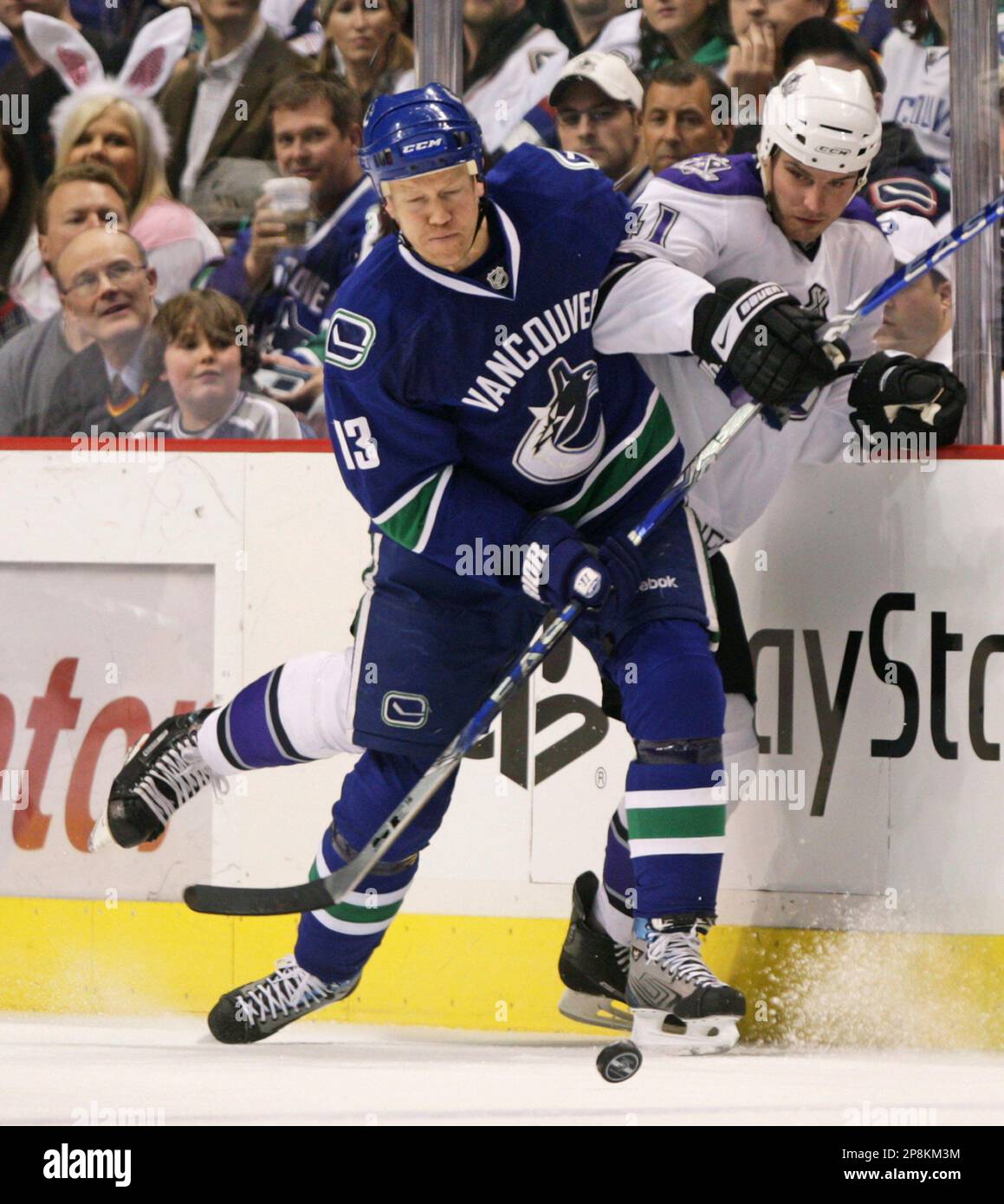 Vancouver Canucks' Mats Sundin, left, of Sweden, checks Los Angeles Kings'  Raitis Ivanans, of Latvia, during the first period of an NHL hockey game in  Vancouver, B.C., on Thursday, April 9, 2009. (