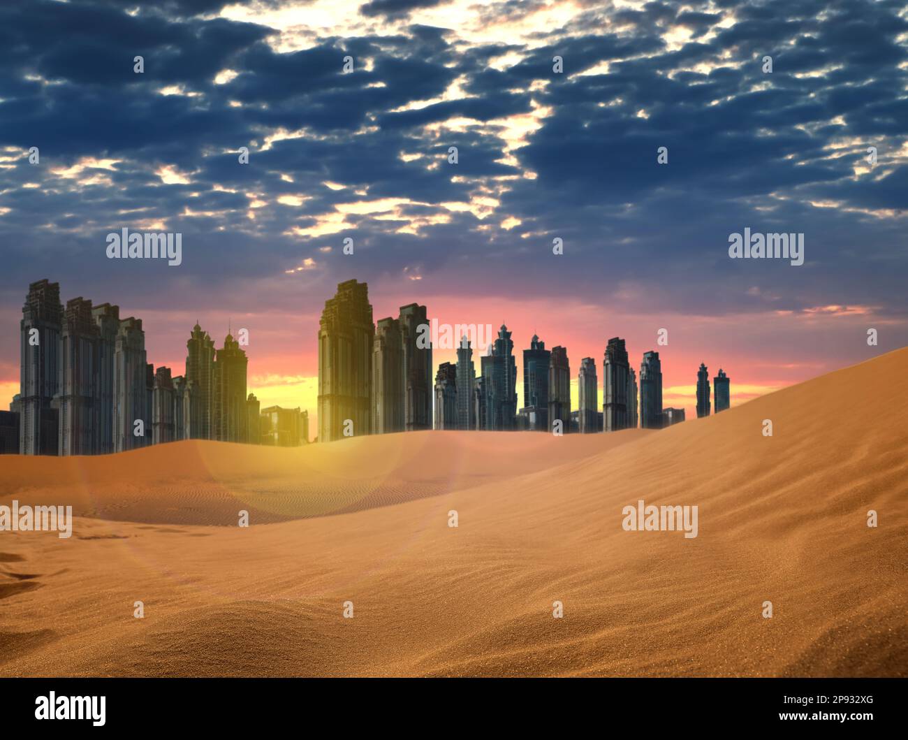 Désert de sable et silhouette de ville à l'horizon au coucher du soleil Banque D'Images