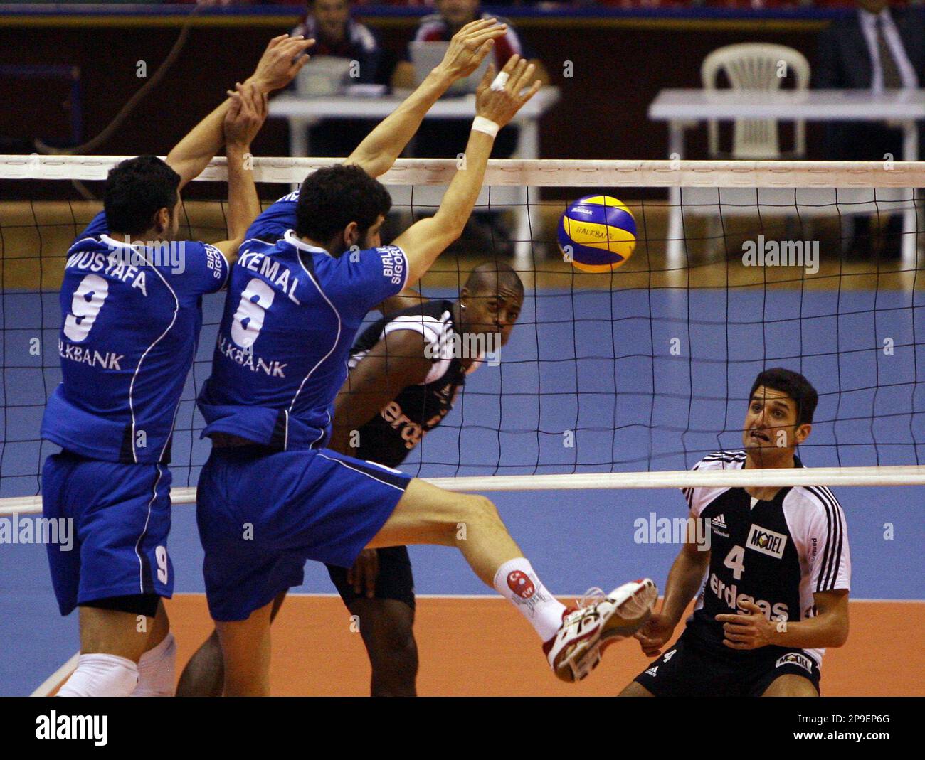 TV Amriswil's Alan Soares of Brazil, rear center, hits the ball as Halkbank players Mustafa Kavaz, left, and Kemal Kayhan try to block during their Volleyball European Cup match in Ankara, Turkey, Wednesday, Nov. 12, 2008. (AP Photo/Burhan Ozbilici) Banque D'Images