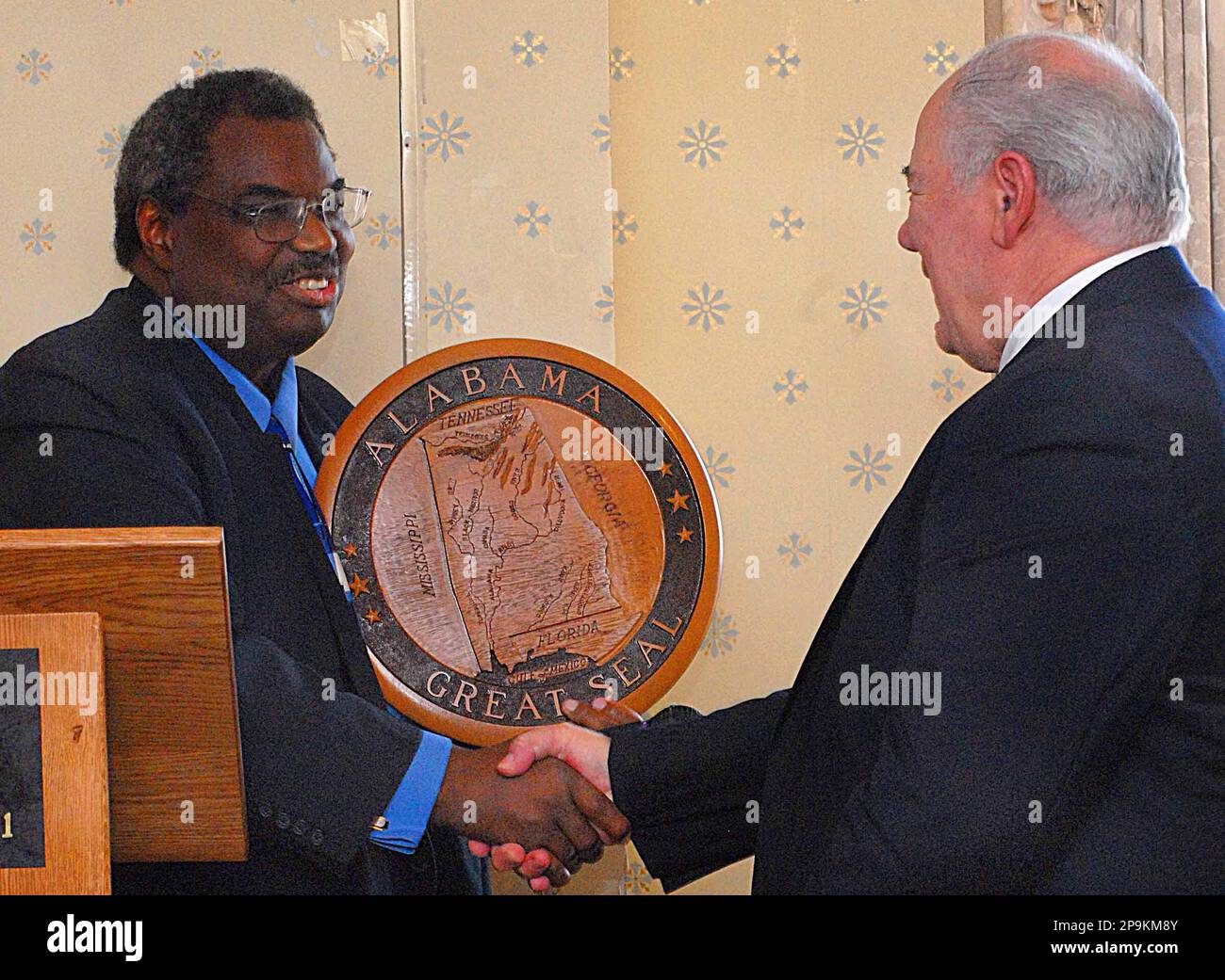 State Sen. Hank Sanders hands a plaque with the Great Seal of Alabama to Jim  Solano, CEO of Alliance Technology Group Inc., during a press conference  Tuesday, Sept.23, 2008, at the St.