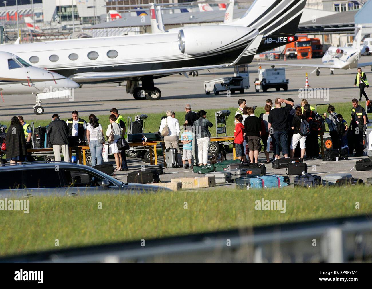 Passengers of an Airbus A-320 of the airline company Swiss International  Airlines identify their luggage on the tarmac of the Cointrin airport in  Geneva, Switzerland, Saturday, Aug. 23, 2008. The plane coming