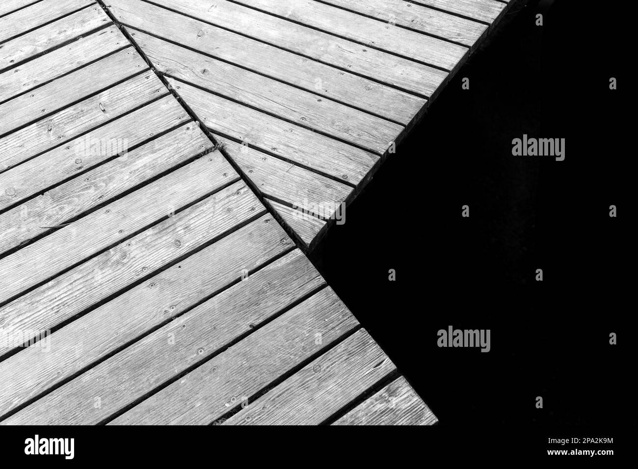 Détail d'une jetée en bois sur un lac dans un style minimaliste noir et blanc Banque D'Images