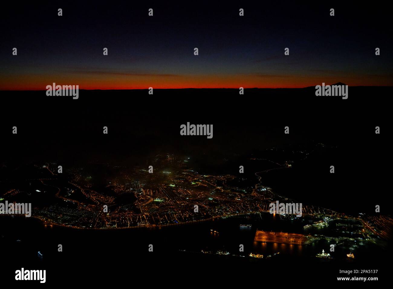 Vue aérienne des lumières de Los Palmas avec la ville et le port la nuit avec lumière du soleil couchant Banque D'Images Vue aérienne des lumières de Los Palmas avec la ville et le port la nuit avec lumière du soleil couchant Banque D'Images