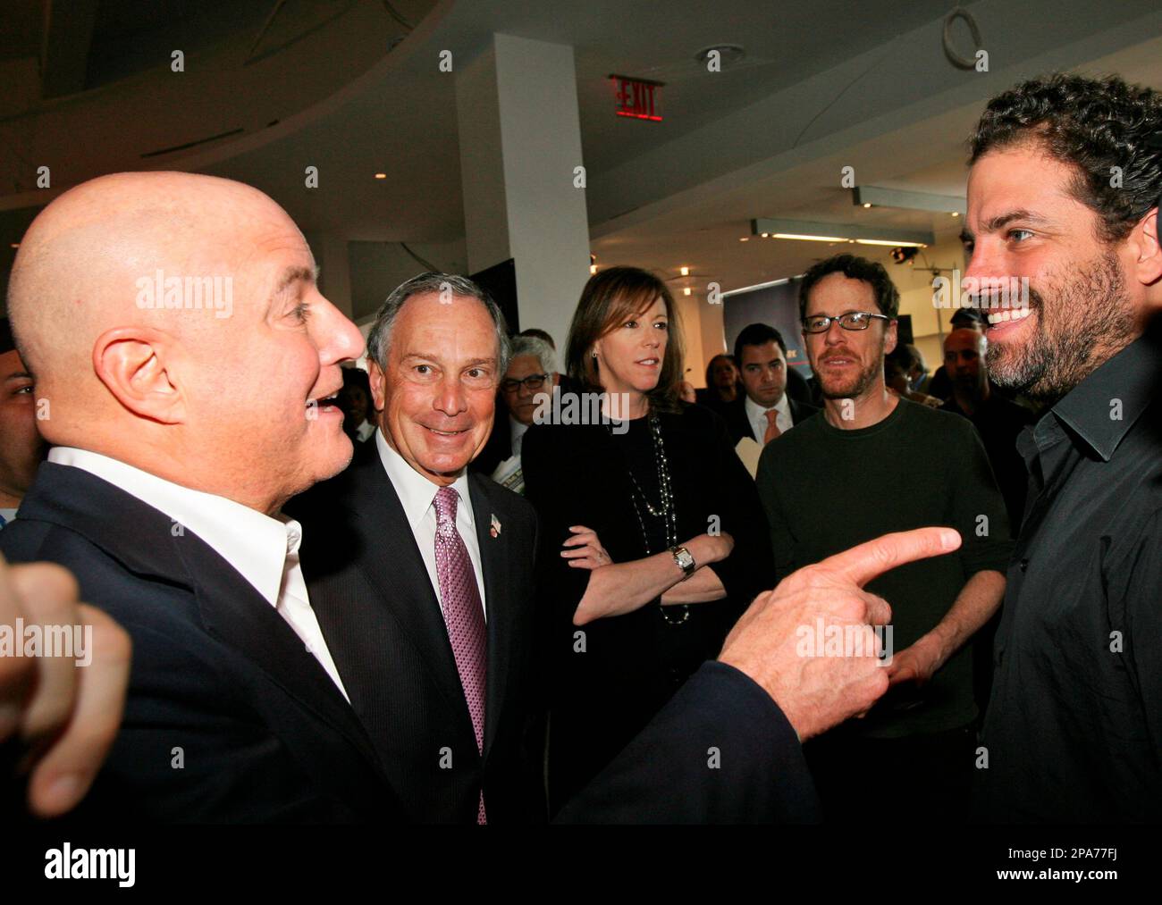 Investor Ronald O. Perelman, left, gestures as he talks, from his left