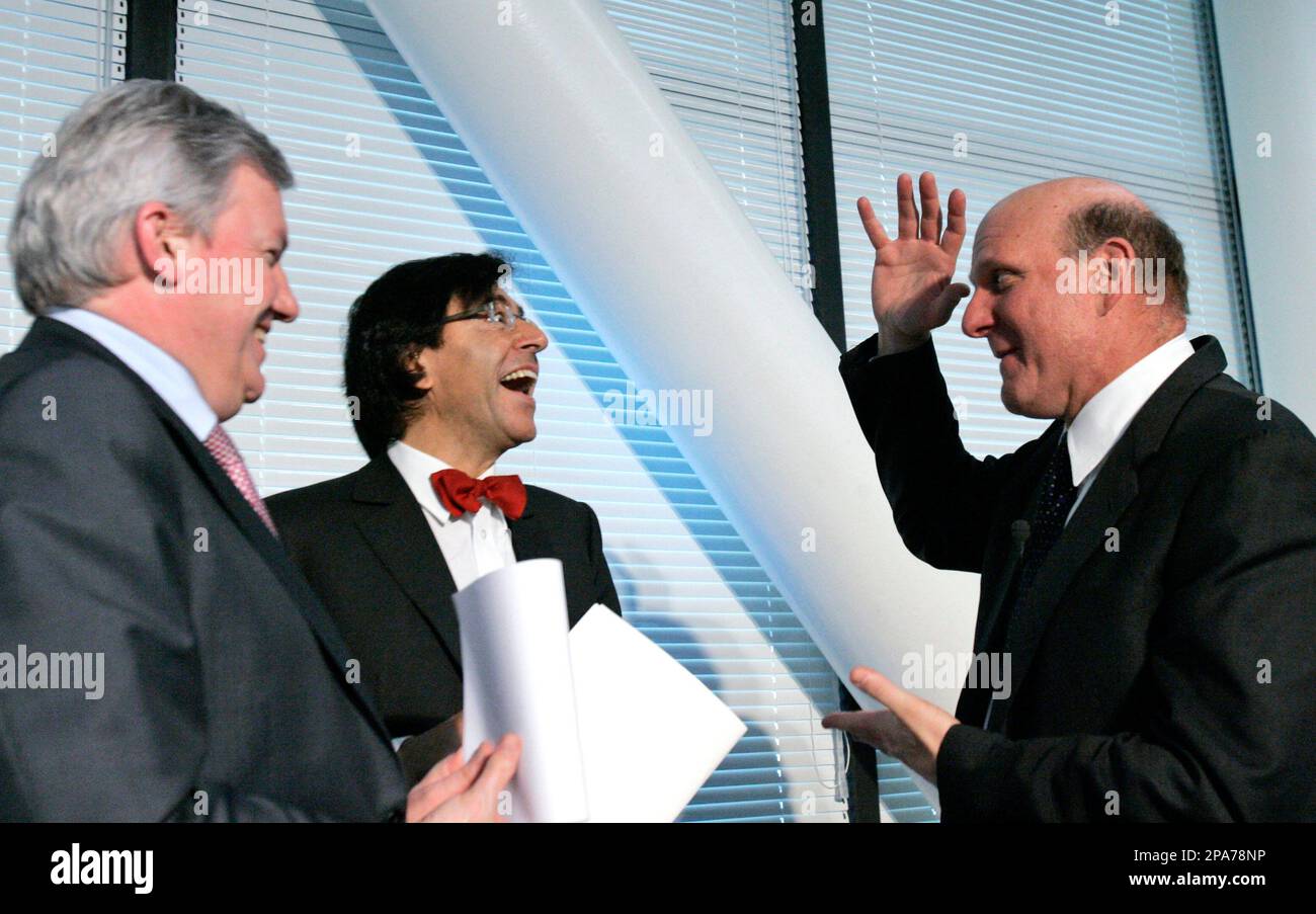 Microsoft CEO Steve Ballmer, right, gestures while speaking with the Mayor  of the Belgian city of Mons Elio di Rupo, center, and Wallonia's Minister  for Economy Jean Claude Marcourt, left, during a