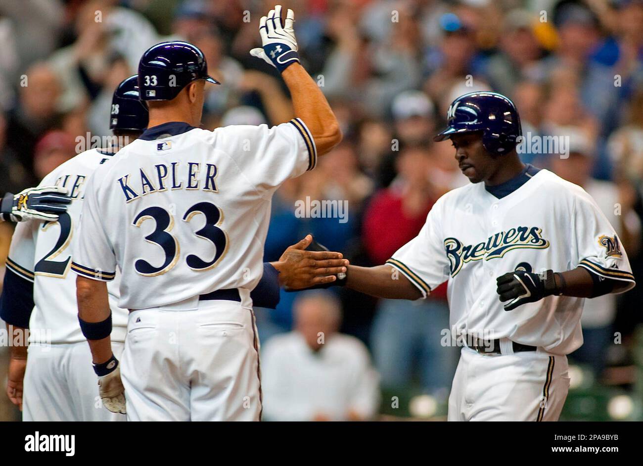 Milwaukee Brewers' Bill Hall, right is congratulated by Prince Fielder, left, and Gabe Kapler, center after he hit a three run home run against the San Francisco Giants during the fifth inning of the baseball game Friday April 4, 2008 in Milwaukee. Brewers beat the Giants 13-4. (AP Photo/Ron Kuenstler) Banque D'Images
