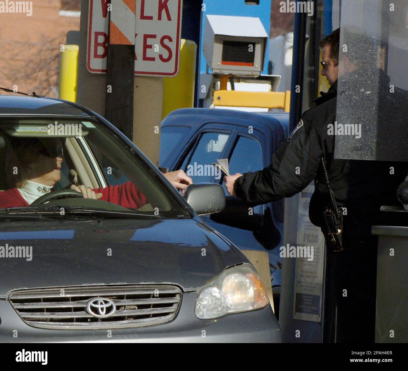 A U. S. Customs and Border Protection officer checks the identification ...