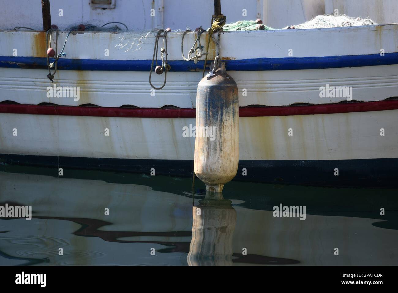 Bateau de pêche grec traditionnel à tribord avec une aile lourde pour ballons et une corde d'amarrage. Banque D'Images