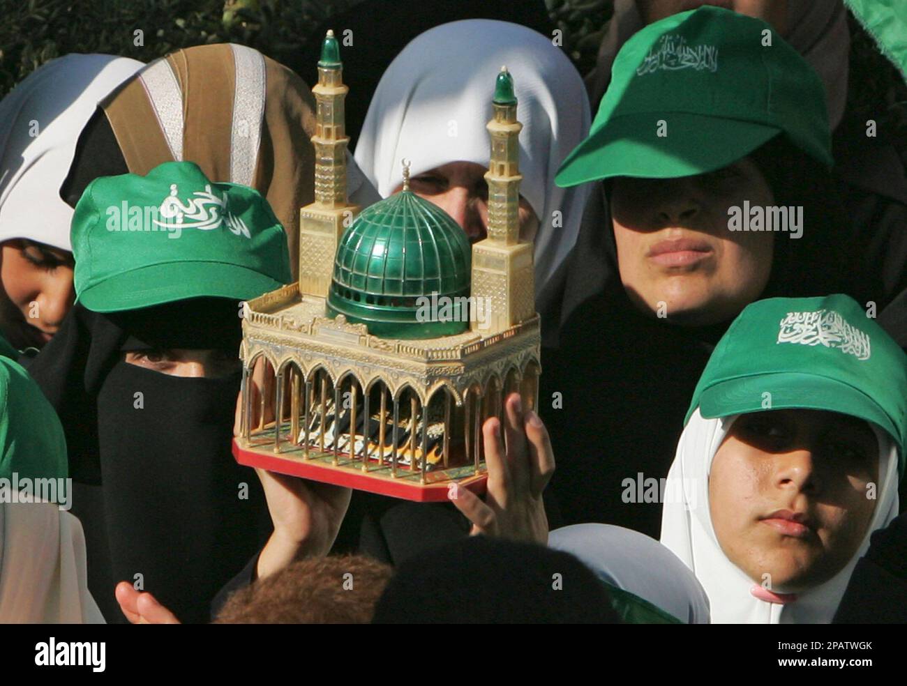 Palestinian female Hamas supporters hold a model of Saudi Arabia's ...