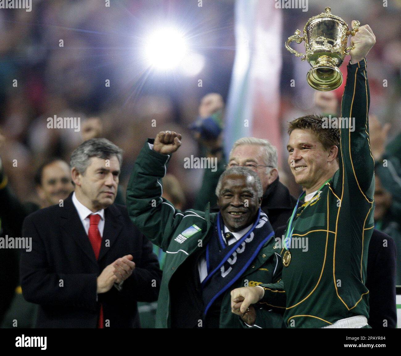 South African captain John Smit right, holds the William Webb Ellis trophy aloft with South African President Thabo M'Beki as British Prime Minister Gordon Brown left, looks on after the Rugby World Cup final match between England and South Africa at the Stade de France stadium in Saint Denis, outside Paris, Saturday Oct.20, 2007. South Africa won 15-6. (AP Photo/Mark Baker) Banque D'Images