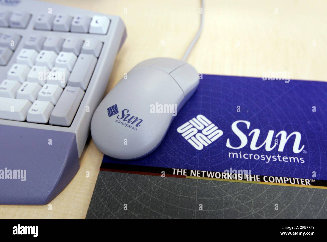 An Sun Microsystems Inc. Mouse Pad, Mouse, And Keyboard Is Shown.