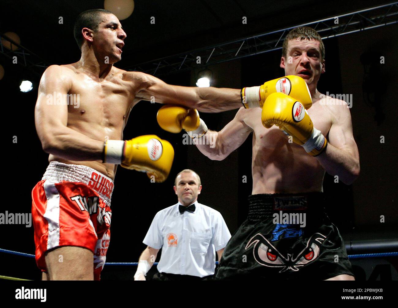 Swiss Farid M'Laika from the Boxing Club Yamabushi of Geneva,left, fights  against Jamie Crawford from Northern Ireland, right, for the european  semifinal of the World Kickboxing Network WKN, in the super middlelight