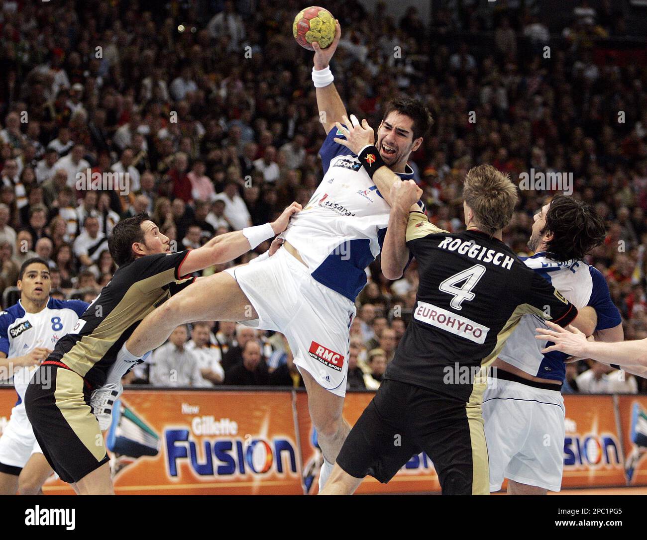 Germany's Torsten Jansen, second left, and Oliver Roggisch, fsecond right, fight against Daniel Narcisse, left, Nikola Karabatic, center, and Bertrand Gille from France, during the Handball World Championships semifinal match between Germany and France in Cologne, Germany, Thursday, Feb. 1, 2007. (AP Photo/Martin Meissner) Banque D'Images