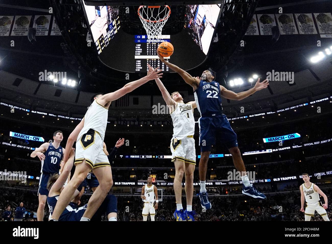 Penn State guard Jalen Pickett, right, battles for a rebound against Purdue center Zach Edey, left, and forward Caleb Furst during the second half of an NCAA college basketball championship game at the Big Ten men's tournament, Sunday, March 12, 2023, in Chicago. (AP Photo/Nam Y. Huh) Banque D'Images