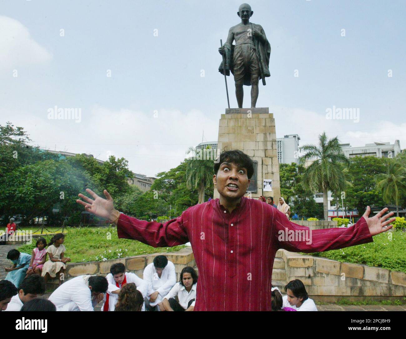 An activist performs a street play to highlight the plight of farmers ...