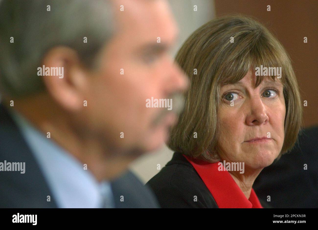 Boulder County District Attorney Mary Lacy, left, looks at investigator