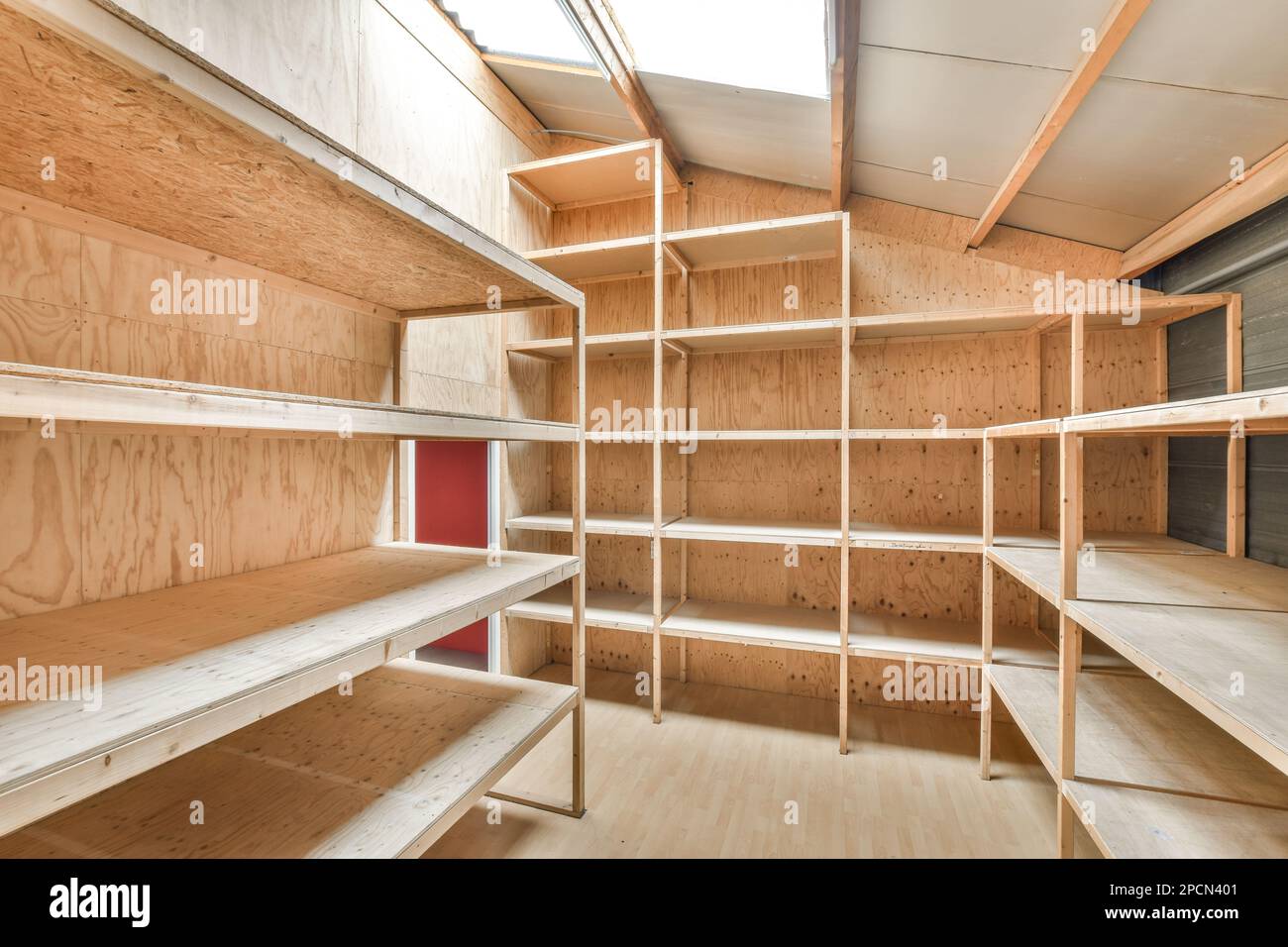 l'intérieur d'une pièce avec des étagères en bois et des étagères de chaque côté, tous faits de contreplaqué Banque D'Images