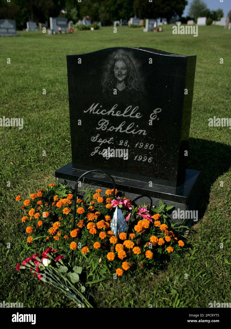 The gravestone of Michelle E. Bohlin is decorated with fresh flowers in