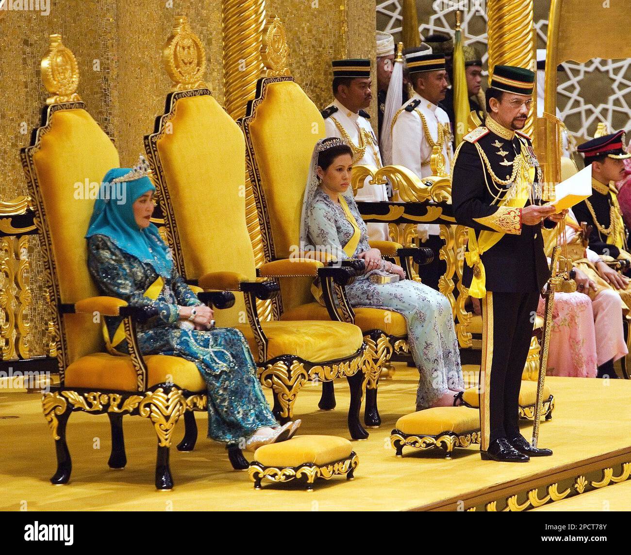 Brunei's Sultan Hassanal Bolkiah, right, flanked by Queen Saleha, left