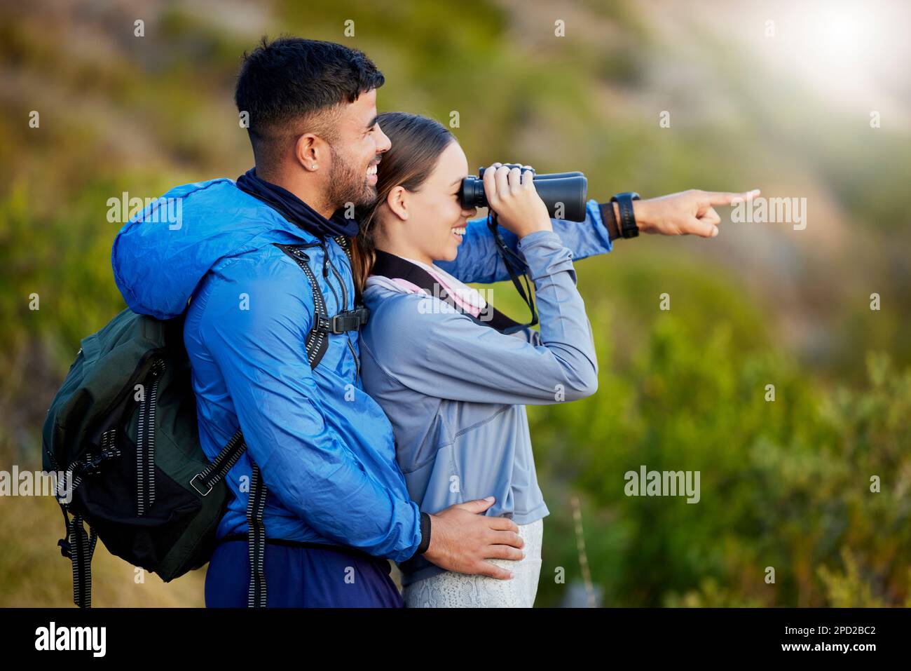 Jumelles, point et un couple observation d'oiseaux dans la nature tout en randonnée dans les montagnes ensemble. Forêt, écologie ou tourisme avec un homme et une femme Banque D'Images
