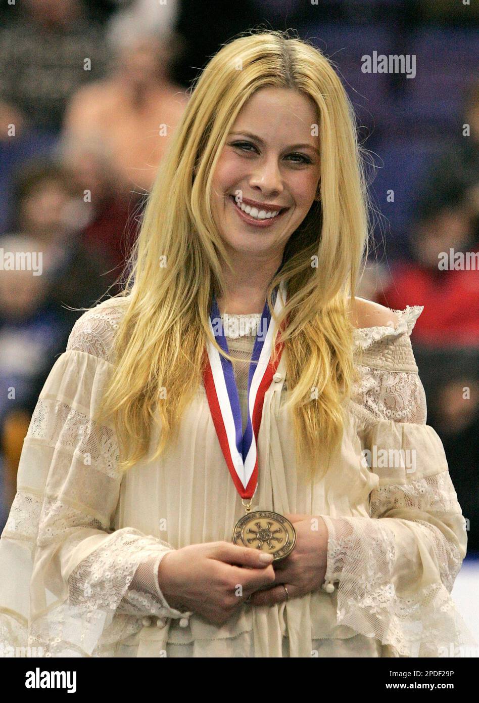 Olympic gold medalist Tara Lipinski shows off the medal presented to