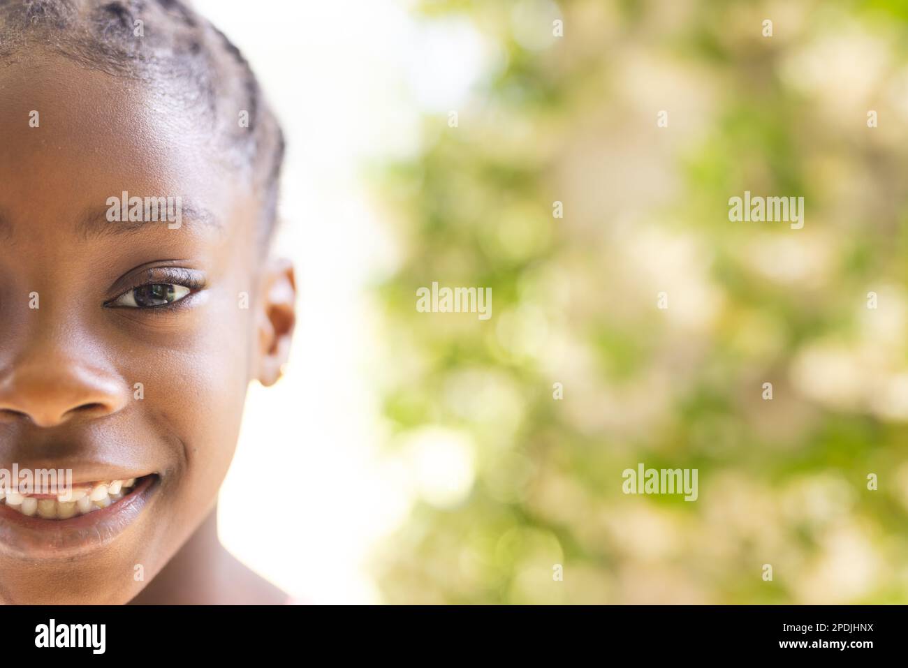 Portrait d'une fille afro-américaine heureuse regardant l'appareil photo et souriant, espace de copie Banque D'Images