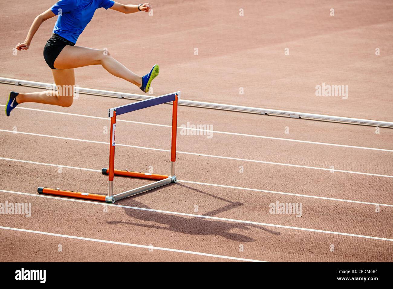 Jeunes athlètes féminins qui courgent des haies au stade, chaussures Nike Spikes pour la course à pied, photos de sport Banque D'Images