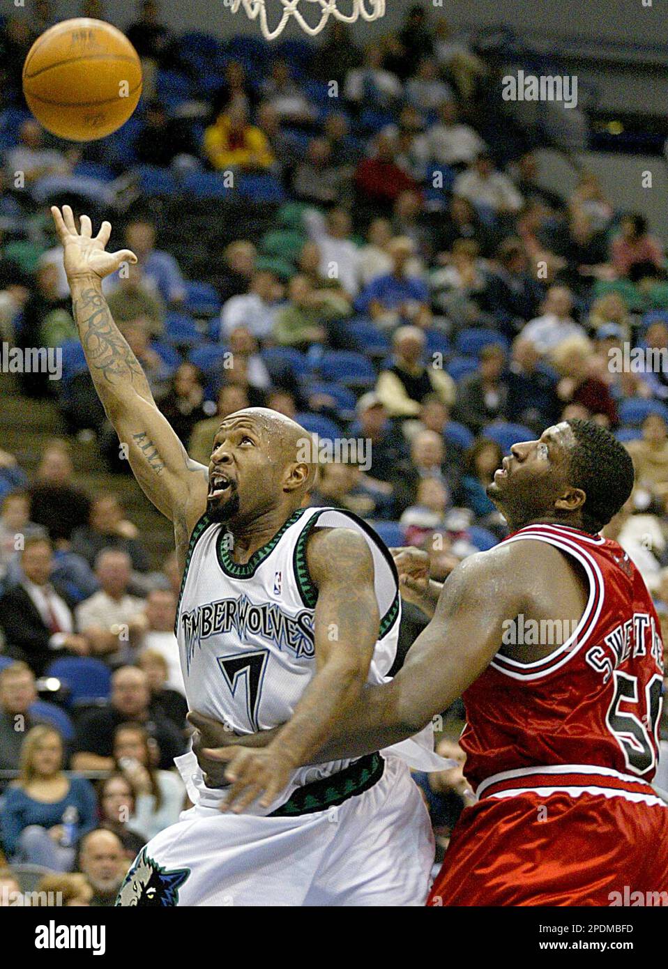 Minnesota Timberwolves guard Anthony Carter, left, is fouled by Chicago Bulls forward Michael Sweetney during the fourth quarter of the Timberwolves' 100-92 victory in Minneapolis, Wednesday, Oct. 26, 2005. Carter made the shot and the free throw. (AP Photo/Andy King) Banque D'Images