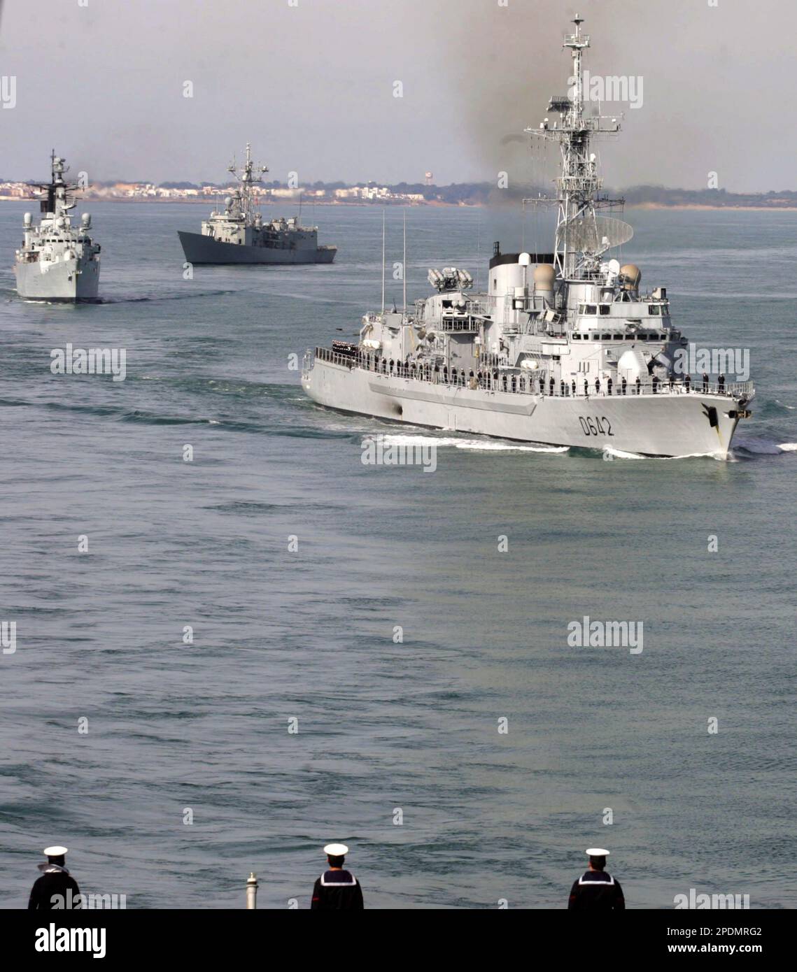 Spanish naval crew members stand to attention onboard the Spanish
