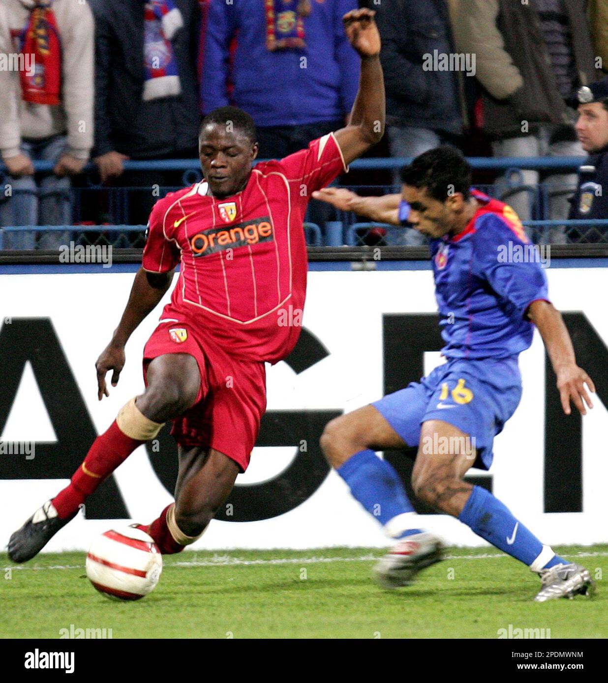 Aruna Dindane, left, of RC Lens duels for the ball with Banel Nicolita of  FC Steaua, during their UEFA Cup, Group C, soccer match, Thursday, Oct. 20,  2005 in Bucharest, Romania. (AP