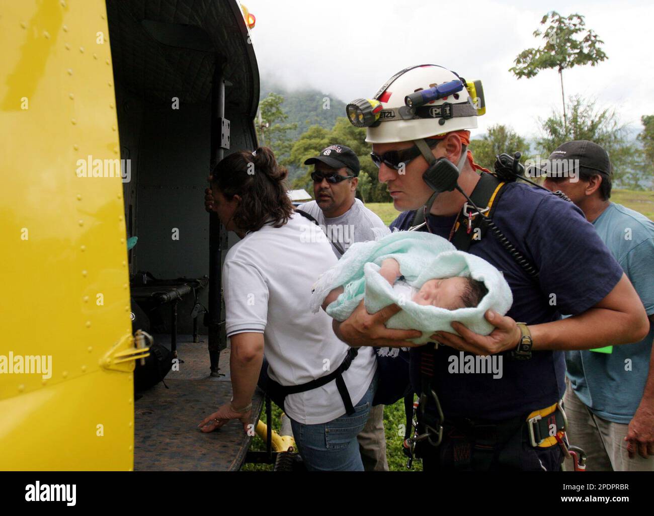 Costa Rican Red Cross worker Jesus Escalona evacuates three month-old ...