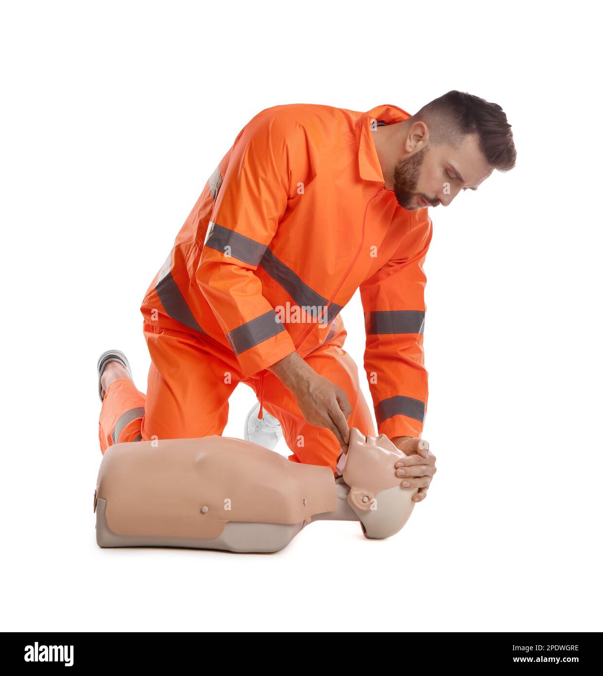 Paramédic en uniforme pratiquant les premiers soins sur un mannequin sur fond blanc Banque D'Images