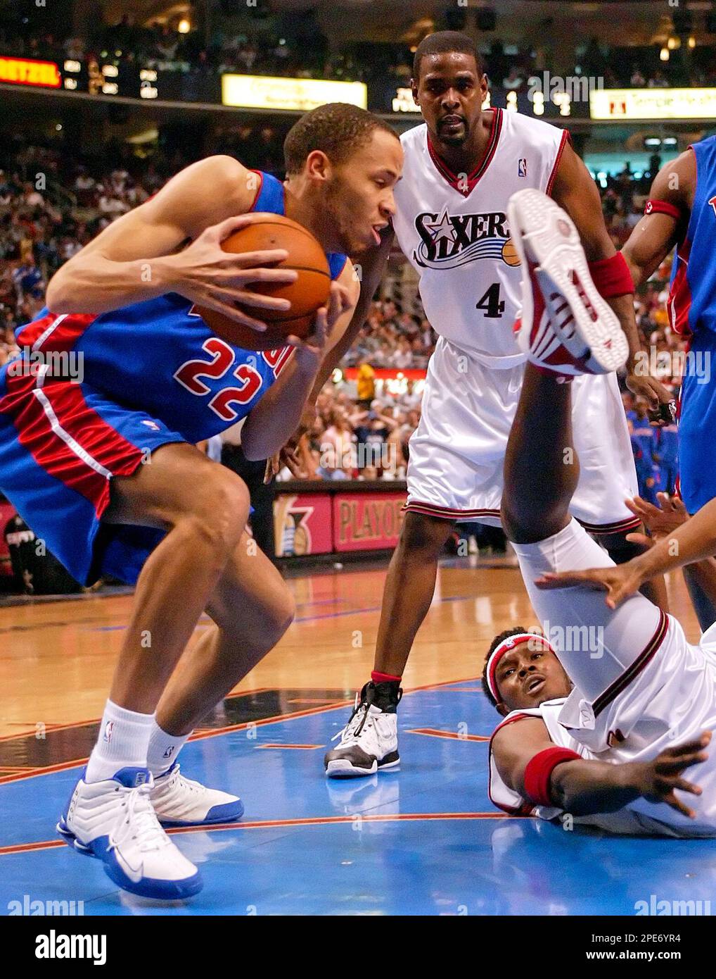 Detroit Pistons' Tayshaun Prince (22) takes a rebound from fallen Philadelphia 76ers Samuel Dalembert, of Haiti, in the first half of their first round Eastern Conference game Sunday, May 1, 2005, in Philadelphia. At rear is Chris Webber (4). (AP Photo/Rusty Kennedy) Banque D'Images
