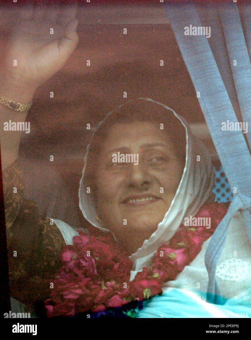 Unidentified pakistani kashmiri woman waves through a bus window as she
