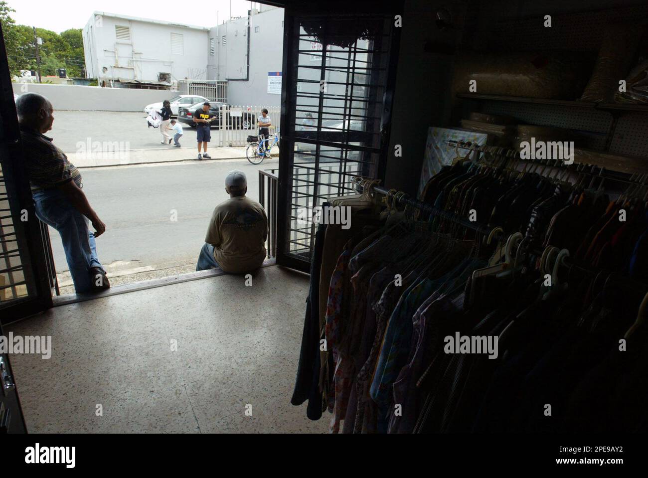 Employees of the clothing store "The rebates of Ceiba" wait for customers on Wednesday, March 30, 2005 in the town of Ceiba, Puerto Rico. A year after the U.S. Navy left the Roosevelt Roads Naval Station, taking with it 6,000 jobs and an estimated $300 million annually, Ceiba is struggling to get by as businesses close, unemployment rises and residents leave the town of 18,000. (AP Photo/Carlos H. Ramos) **EFE OUT** Banque D'Images