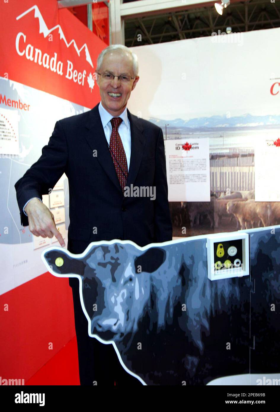 Canadian Ambassador to Japan Robert G. Wright points the cutout of a cow at the Canadian Beef Export Federation booth at Foodex Japan 2005, one of the largest food shows in the region, in Chiba, east of Tokyo, Wednesday, March 9, 2005. A total of 75 countries and regions displayed their products to the 30th international food and beverage exhibition. (AP Photo/Katsumi Kasahara) Banque D'Images