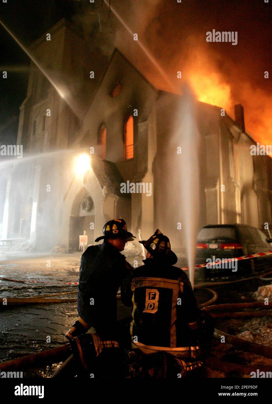 Boston firefighters spray water on the remains of the First Baptist Church in Boston's Jamaica Plain section Tuesday, Jan. 18, 2005. The church, which was built in 1859, caught fire around 5:30 p.m. Tuesday. (AP Photo/Steven Senne) Banque D'Images