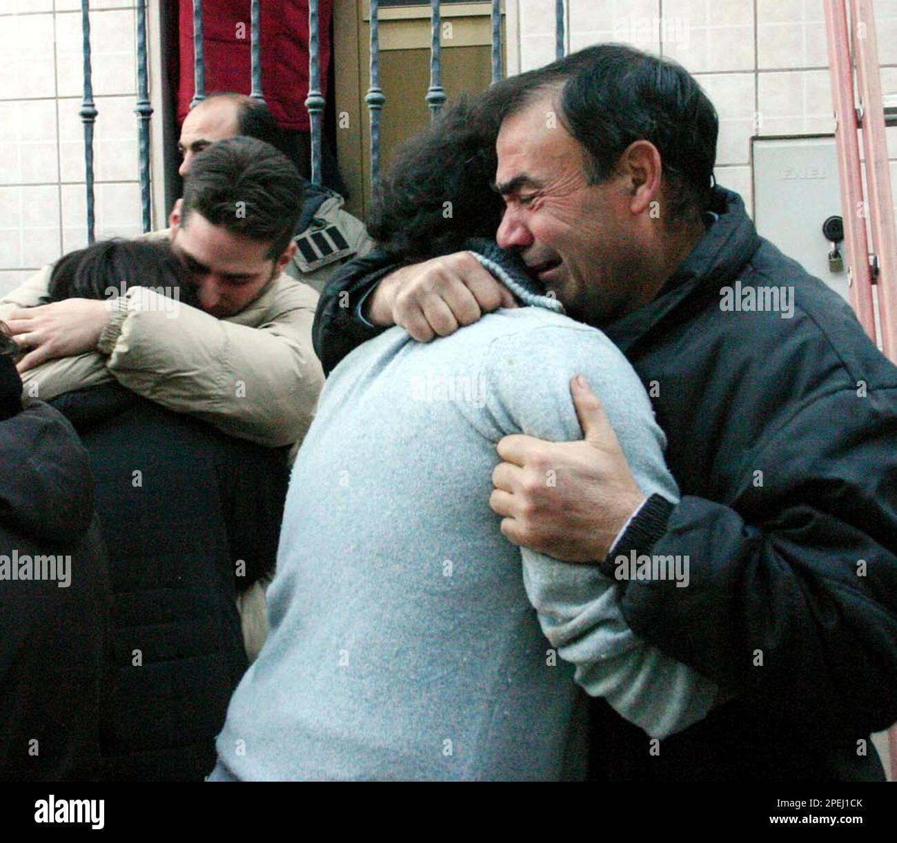Relatives of the victims of a house collapse cry and comfort eachother ...