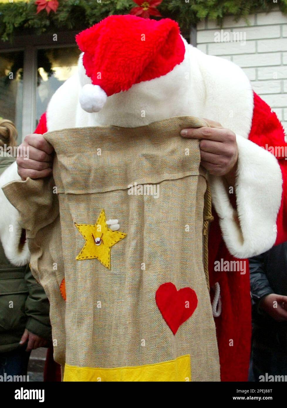 ein-weihnachtsmann-schaut-in-seinen-sack-als-er-geschenke-vor-einer