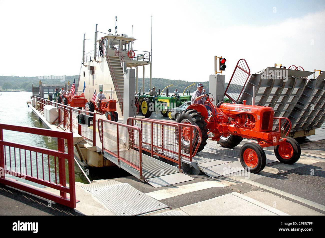 A convoy of 14 antique farm tractors drives off the Merrimac Ferry in Merrimac, Wis. on Wednesday, Aug. 18, 2004 on the way to the annual Badger Steam and Gas Engine Show this weekend near Baraboo, Wis. This group of friends is coming from the DeForest and Sun Prairie area, and includes farmers and several from various other occupations. (AP Photo/Baraboo News, Tom Michele Banque D'Images