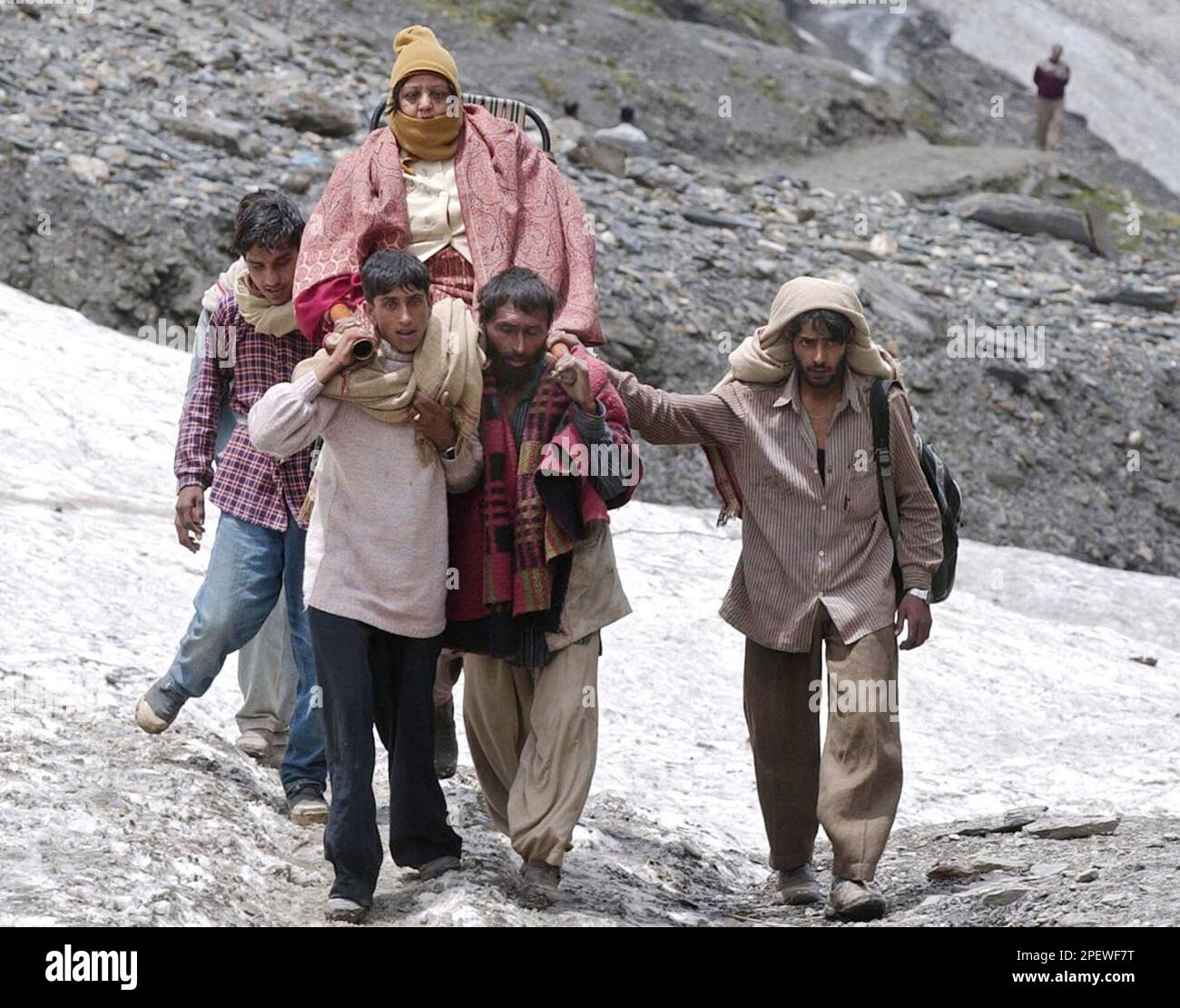 Kashmiri Porters Carry A Hindu Pilgrim On A Wooden Palanquin Through A Glacier Near The Holy