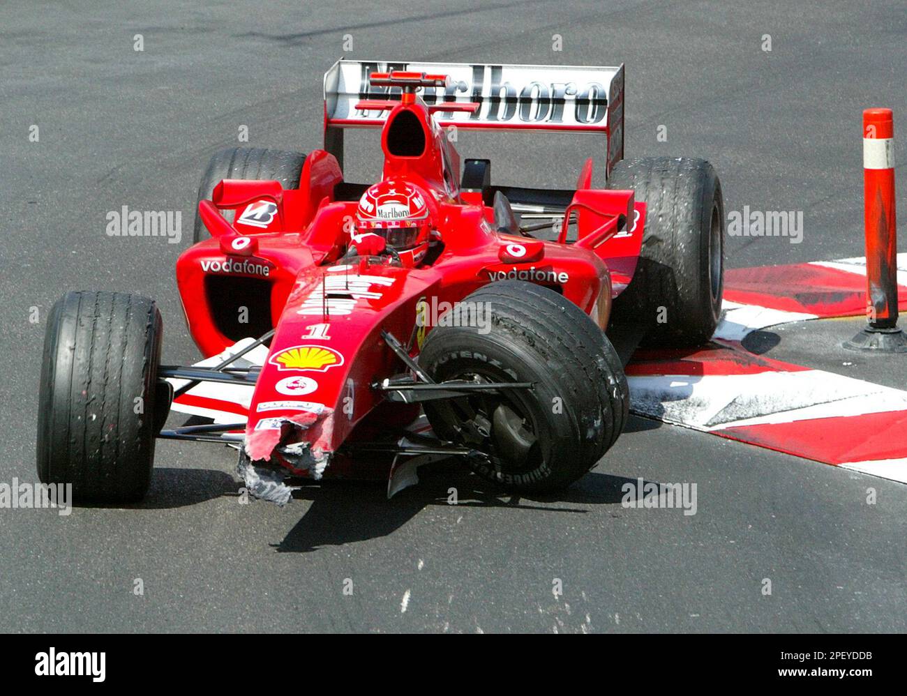 Michael Schumacher of Germany steers his damaged Ferrari towards the pit area after crashing in the tunnel of the Monaco street circuit during the Monaco Grand Prix, Sunday, May 23, 2004. Jarno Trulli of Italy on Sunday became the first driver other than Michael Schumacher to win in Formula One this season, in a dramatic Monaco Grand Prix that saw the German star retire after a bizarre crash. (AP Photo/Jean-Loup Gautreau, Pool) Banque D'Images